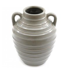 A grey stoneware vase with a symmetrical double handled design and ribbed texture. 