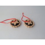 A hanging ceramic decoration in the shape of a mince pie, hung from festive ribbon