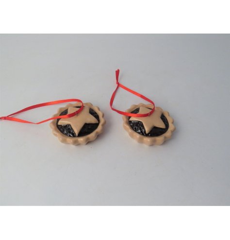 A hanging ceramic decoration in the shape of a mince pie, hung from festive ribbon