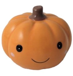 A cute ceramic pumpkin ornament. An adorable seasonal gift item and interior decoration. 