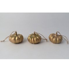An assortment of 3 luxe pumpkin decorations in brushed gold