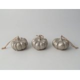 An assortment of 3 champagne coloured hanging decorations in a pumpkin design