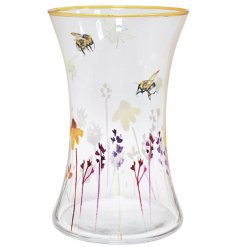 A clear glass vase with painted floral meadow and bee design and gold rim detail. 