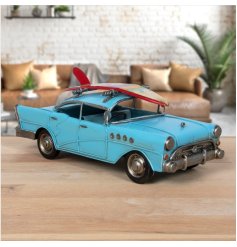 A retro style metal car decoration with surf board detail in a vibrant blue colour. 