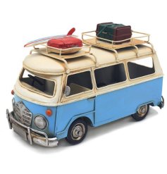 A cool and stylish vintage style camper van decoration with a colourful blue finish and skate board/luggage details. 