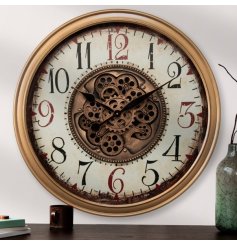 A large wall clock with central cog mechanism design, gold edging, clock hands and numbers with a beautiful background.