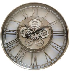 A large wall clock with cut out features and roman numerals, cog design and beautiful silver colour scheme. 