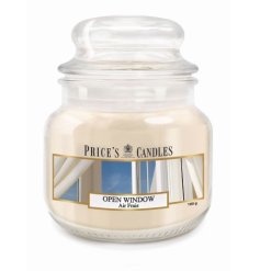 A stylish lidded glass jar candle with a fresh open window scent. 