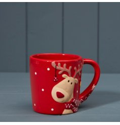 A red festive mug with a Reindeer dressed in a scarf and baubles hung from its antlers design.