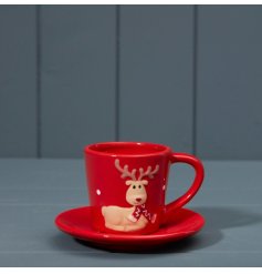 a nordic cup and saucer set in red, featuring a sitting Rudolph wearing a red scarf