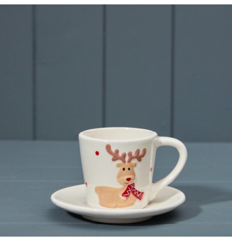 white cup and saucer set featuring a cheeky reindeer wearing a red scarf