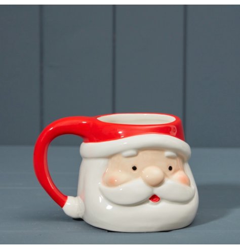 A festive Santa character mug in red and white colours.