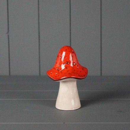 A charming decoration featuring a woodland mushroom in dark red tones.