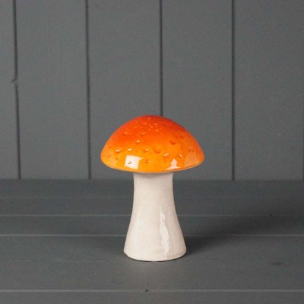 A glazed orange mushroom decoration with a natural stone effect stalk.
