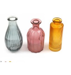 A set of 3 coloured glass vases in earthy blue, pink and yellow colours. 