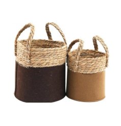 A set of 2 stylish storage baskets in earthy brown and caramel colours with a woven rattan band.
