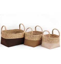 A set of 3 stylish and practical storage baskets in a mix of earthy neutral colours, each with a rattan band and handles