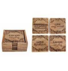 A set of 4 natural wooden coasters, each with a stylish laser cut design featuring flowers and a popular slogan.