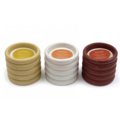 3 Assorted scented wax candles featuring a ribbed design.