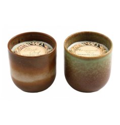 2 assorted candle pots with sweet fragrances displayed in a pot made from earthy tones