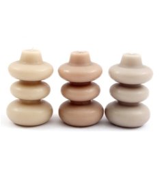 3 Assorted wax candles, each with a bold ribbed design in a neutral colour scheme. 