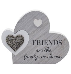 A plaque with "Friends are the family we choose" message