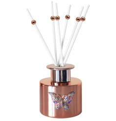 A stylish rose gold diffuser with a beautiful jewelled butterfly.