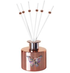 A beautiful rose gold diffuser with a colourful jewelled butterfly design. 