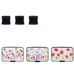 An assortment of 3 credit card protectors, each with a vibrant floral meadow design. 