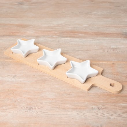 A wooden tray with 3 ceramic star dishes
