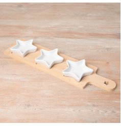 A wooden tray with 3 ceramic star dishes