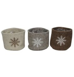 An assortment of 3 lined fabric planters each with a Scandi snowflake design. 