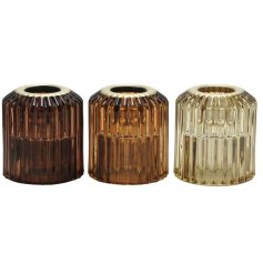 A mix of 3 ribbed glass candle holders in luxurious gold, honey and brown hues. 