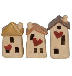 An assortment of 3 charming houses with red hearts and a reactive glaze finish. A quirky and unique interior accessory 