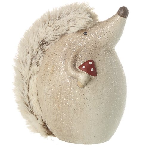 A charming little hedgehog covered in glitter holding a mini toadstool