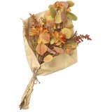 A beautiful artificial bouquet featuring flowers, foliage and berries.