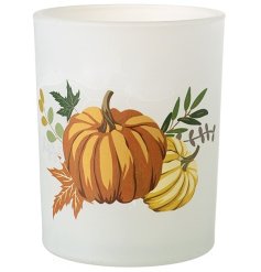 An opaque glass candle holder with a stylish autumnal pumpkin motif. 