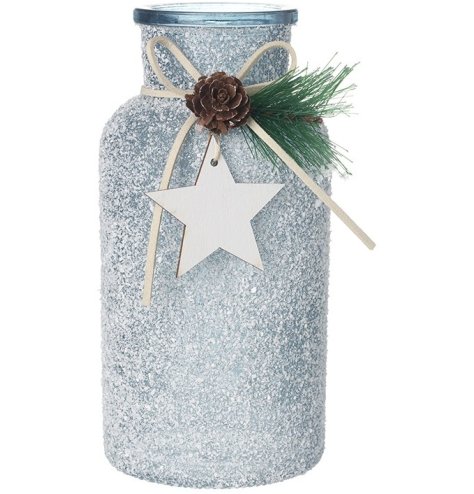 A sparkling silver glass vase with a textured, mottled finish, wooden star charm and seasonal foliage. 