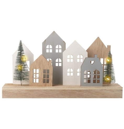 Village house scene with twinkling LED's entwined through two trees