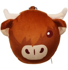 A  travel pillow and eye mask in a animated highland cow design