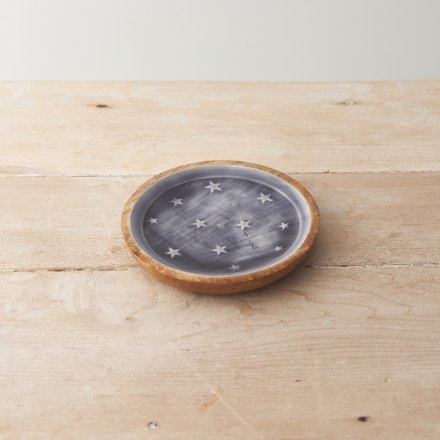 A rustic styled plate displayed with white stars on a blue base. Use this plate as a stand for home accessories