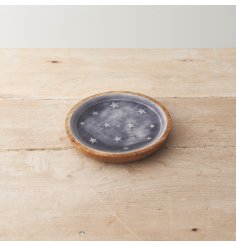 A rustic styled plate displayed with white stars on a blue base. Use this plate as a stand for home accessories