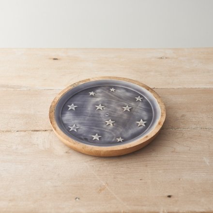 A wooden plate decorated with white stars on a blue enamel base.