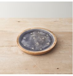 A wooden plate decorated with white stars on a blue enamel base.
