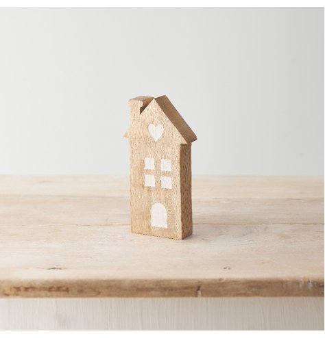 A sweet house decoration made from mango wood with contrasting window details and heart motif. 