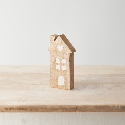 A charming mango wood house decoration featuring contrasting details including windows and heart motif. 
