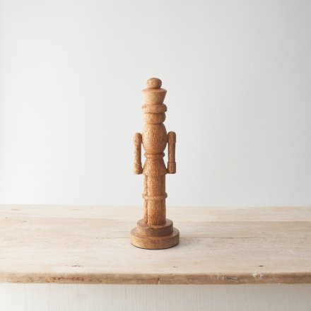 A stylish nutcracker carved from mango wood. A Scandi inspired decoration with a smooth finish and rustic wood grain. 