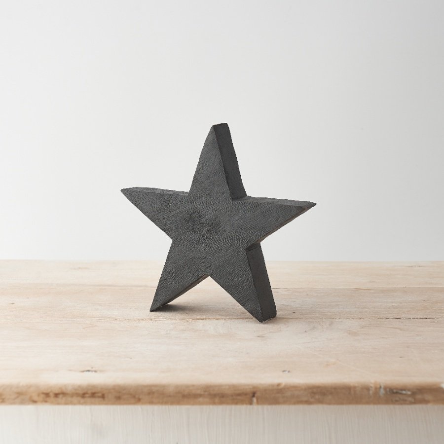 A stylish and contemporary star made from natural mango wood. With visible wood grain and a black painted finish. 