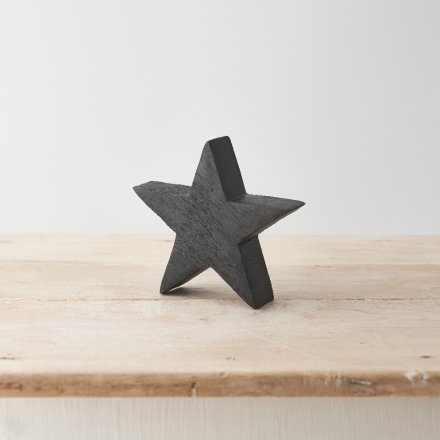 A beautifully crafted star made from natural mango wood with a black painterly finish. 