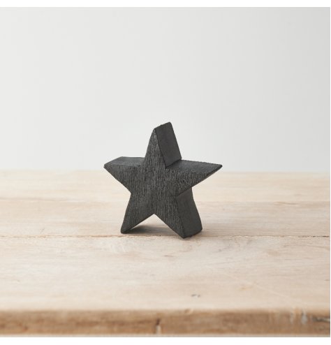 A chunky wooden star with a textured, black finish. A stylish accessory for the home this season. 